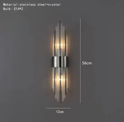 Modern gold stainless steel wall lamp with sleek vertical design and clear crystal accents for bedroom sconce lighting