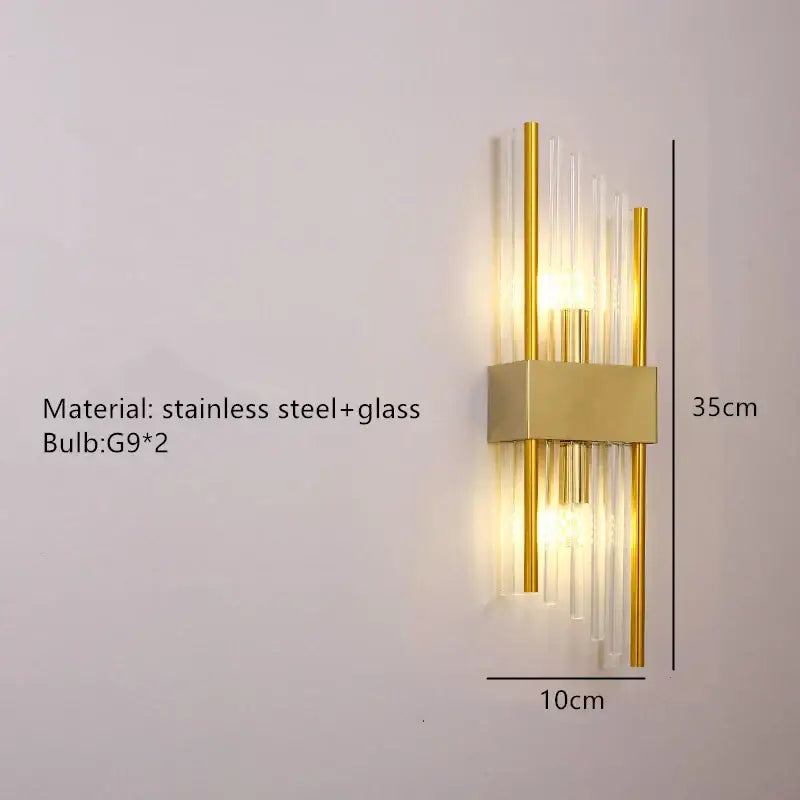 Modern gold stainless steel wall lamp with clear crystal tubes and g9 bulbs designed as a bedroom sconce