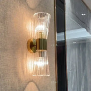 Modern gold stainless steel wall sconce with fluted glass shades and warm light for bedroom decorbites gold stainless