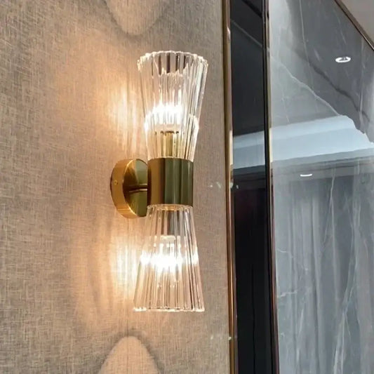 Modern gold stainless steel wall sconce with fluted glass shades and warm light for bedroom decorbites gold stainless