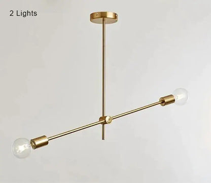 Modern gold starburst pendant light with brass finish and two exposed bulb fixtures for dining room decorbites glass ball globe