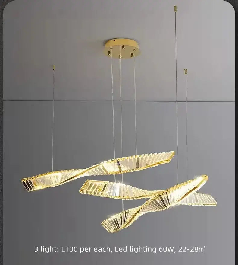 Modern gold steel led pendant light with three intertwined ribbon-like crystal arms for dining room decorbites gold steel chandelier