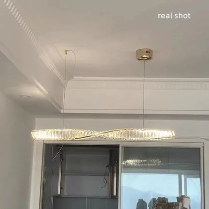 Modern gold steel led pendant light with twisted design and crystal accents for dining room decorbites gold steel