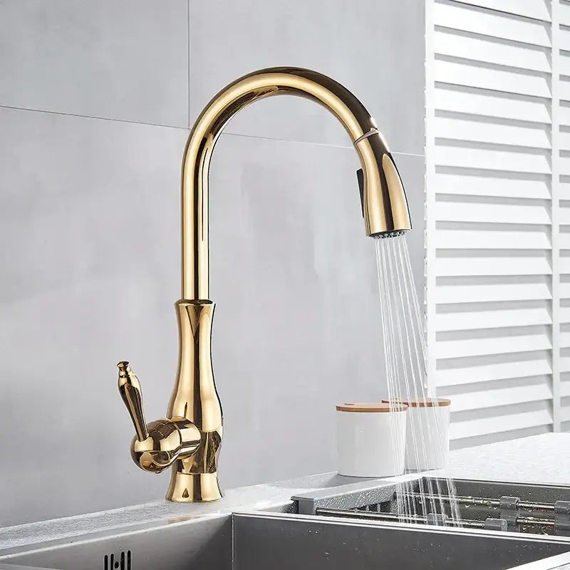 Modern gold swivel kitchen faucet with pull down sprayer featuring a sleek curved design by decorbites gold