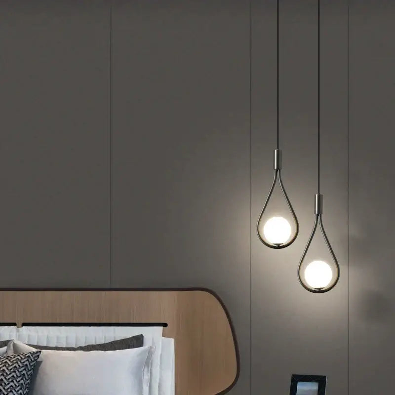 Two modern gold teardrop glass ball pendant lights with brushed metal frames and warm glass globes for kitchen decorbites decor
