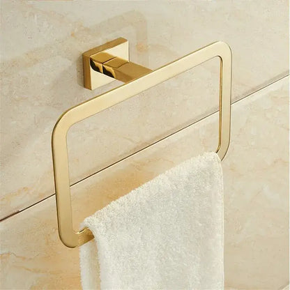 Modern gold towel ranger accessory rack with gold finish and sleek design mounted on a tiled bathroom wall