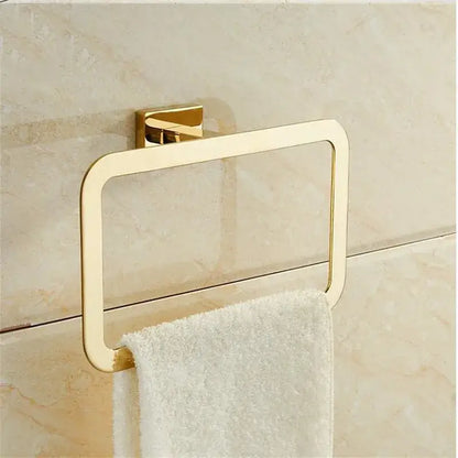 Modern gold towel ranger accessory rack with sleek gold-toned rectangular design mounted on tiled wall