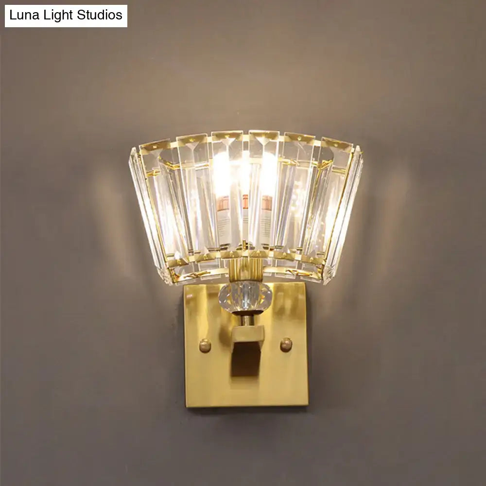 Modern gold trapezoid wall sconce with faceted crystal blocks shade and polished brass mounting plate for living room lighting