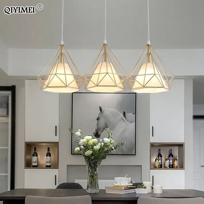 Three decorbites gold triangle pendant lights with gold-toned metal frames and warm white glass shades for dining room decor