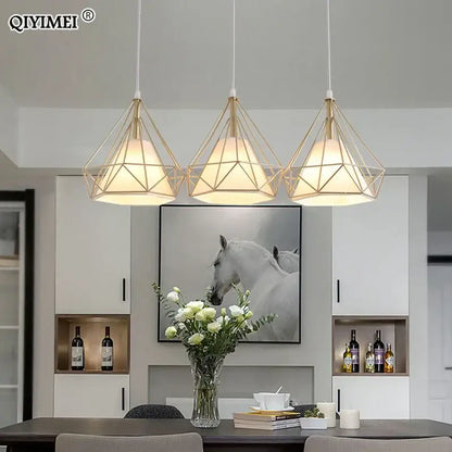 Three decorbites gold triangle pendant lights with gold-toned metal frames and warm white glass shades for dining room decor