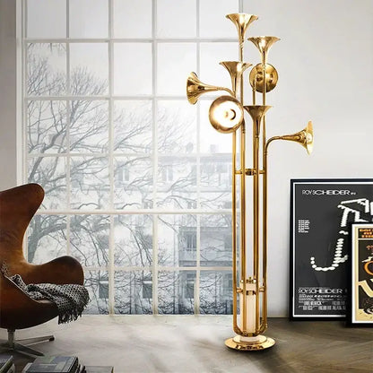 Modern gold trumpet pendant chandeliers featuring a golden brass trumpet-shaped floor lamp with multiple horn-like arms