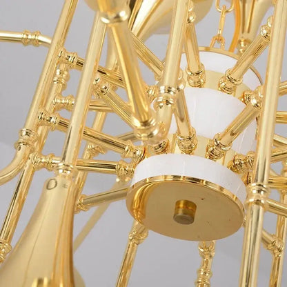 Modern gold trumpet pendant chandelier with intricate brass arms and white ceramic accents for dining room decorbites gold trumpet