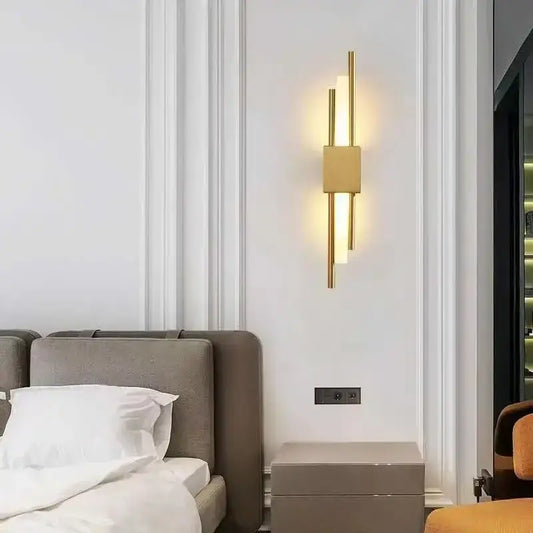 Modern gold tube wall sconce with vertical cylindrical rods and beige fabric diffuser for bedroom decorbites gold tube wall