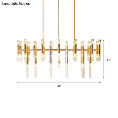 Gold-toned DecorBites tubular led island pendant with clear glass candle elements and geometric linear design for dining room