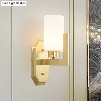 Modern gold tubular wall lamp with frosted glass cylinder shade is a stylish living room product fixture