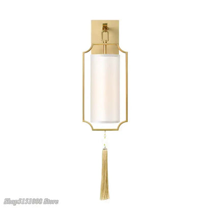 Modern gold wall light featuring a gold-toned rectangular frame with frosted glass cylinder shade and tassel decorbites copper wall lights