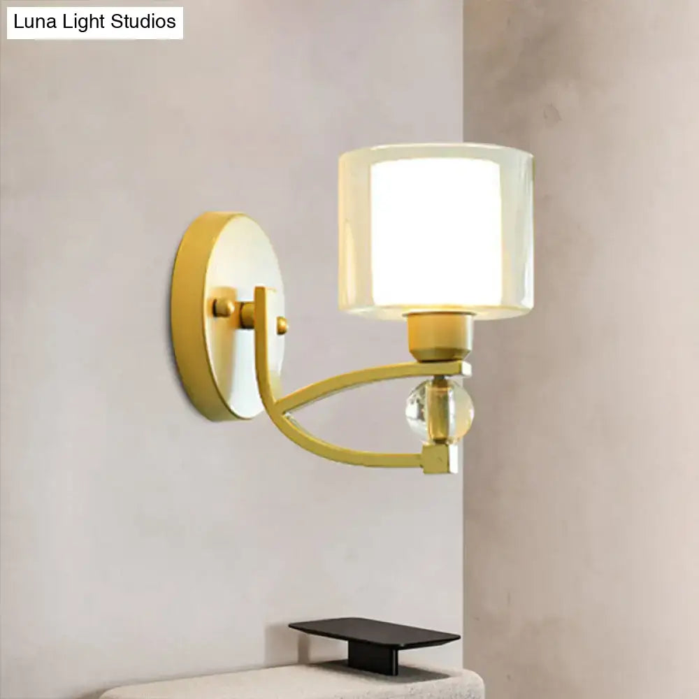Modern gold wall mounted lamp with cylindrical frosted glass shade and crystal accent bead for indoor wall use