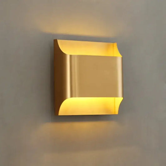 Modern gold wall sconce with sleek metallic finish and curved edges minimalist wall lamp by decorbites copper brass