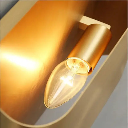 Modern gold wall sconce with warm-toned brushed brass and clear glass bulb ideal as a minimalist living room wall lamp decorbites copper brass