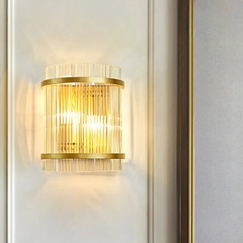 Modern gold wall sconce featuring vertical clear crystal rods designed for elegant hallway lighting