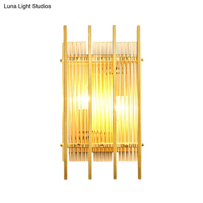 Modern gold wall sconce with clear crystal rods and warm glowing light for elegant hallway lighting