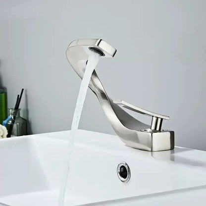 Modern chrome-finished decorbites brass basin faucet with sleek curved design for bathroom sink use