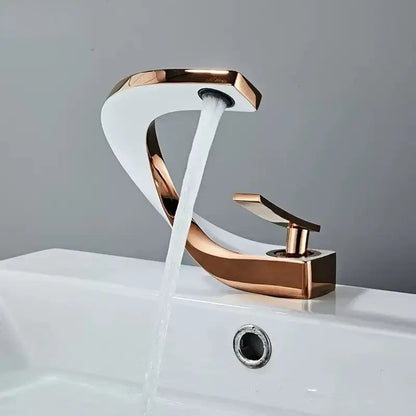 A sleek rose gold brass basin faucet with modern curved design and flowing water for bathroom decorbites brass basin use