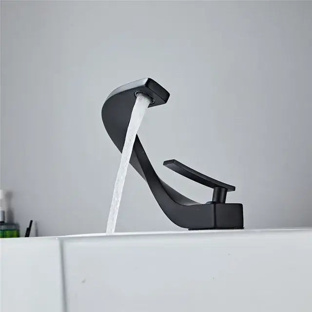 Modern black matte-finish faucet with sleek curved spout complements decorbites gold white bathroom basin design