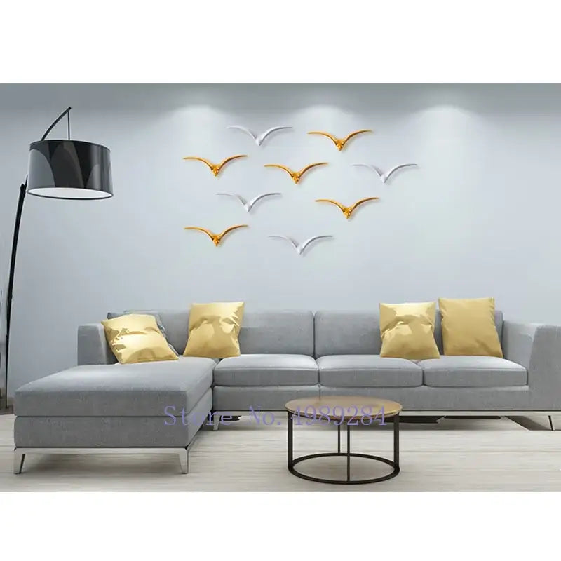 Modern gold and white ceramic pendant wall decor featuring silver and gold metallic bird wall decor decals for living room