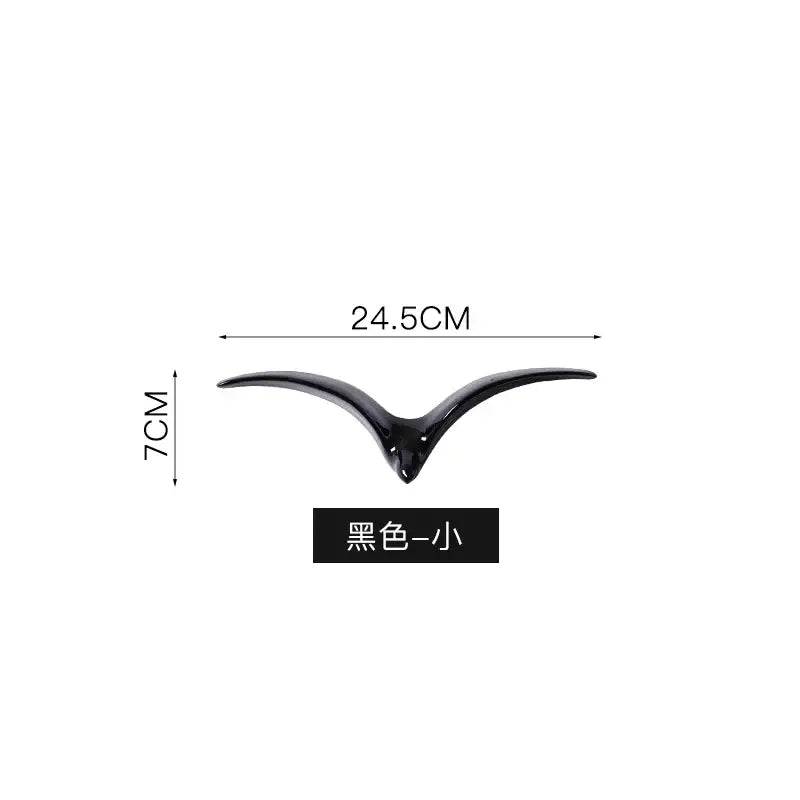 Black glossy ceramic bird-shaped pendant wall decor measuring 24.5 cm wide and 7 cm tall for modern living room