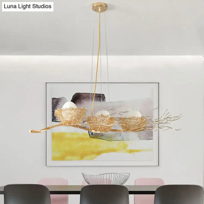 Gold-toned wire mesh bird nest chandelier with three egg-shaped bulbs for modern restaurant lighting