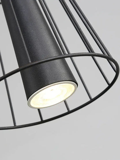 Black cylindrical gravity suspension lamp with matte finish and wire cage design for modern dining rooms