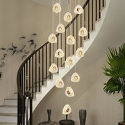 A modern golden acrylic led chandelier with cascading clear crystal teardrop lights for living room decorbites golden acrylic