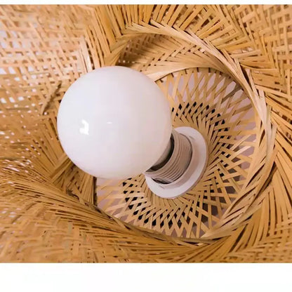 Modern golden bamboo woven chandelier tea room pendant light with a white spherical bulb inside a woven bamboo shade
