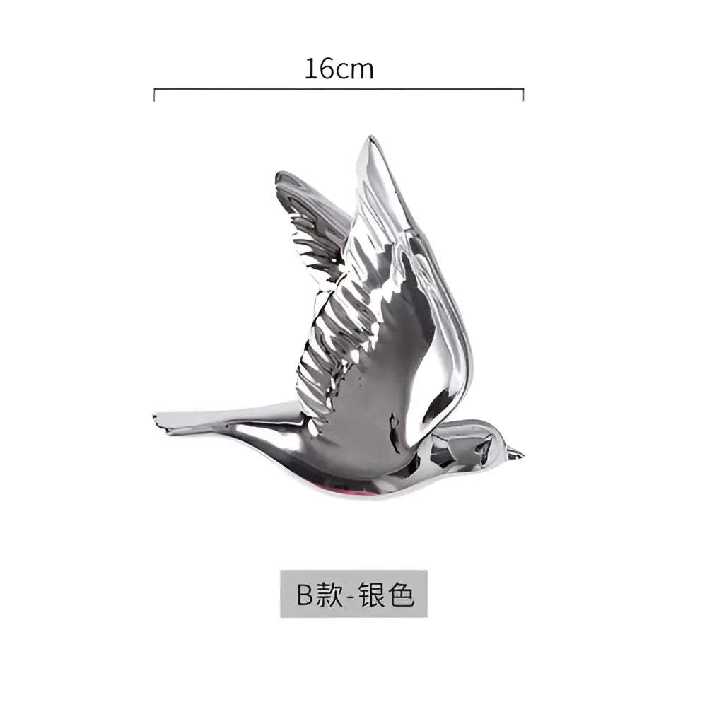 Silver metallic bird figurine with detailed wings and reflective finish as modern golden bird wall hanging decor