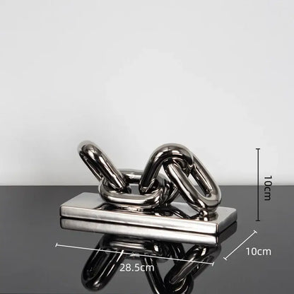 Shiny metallic golden chain home decoration figurine sculpture with interlocking links on a rectangular base