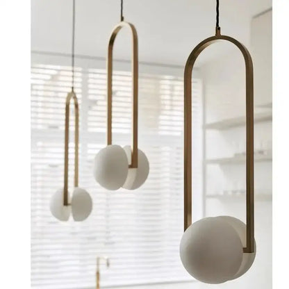 Modern brass arched pendant lights with frosted white glass spheres for dining room decorbites golden chandelier led