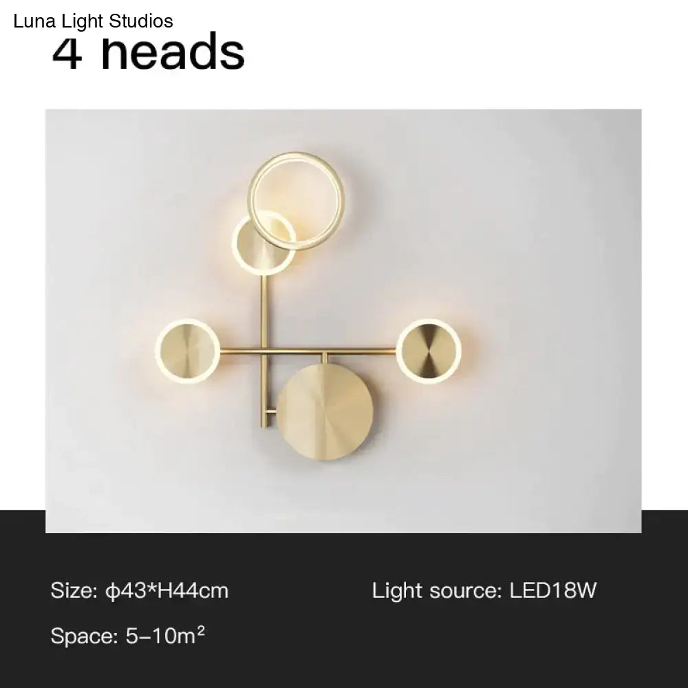 Modern gold-toned living room wall lamp with four circular led light heads in a geometric design led wall lamp