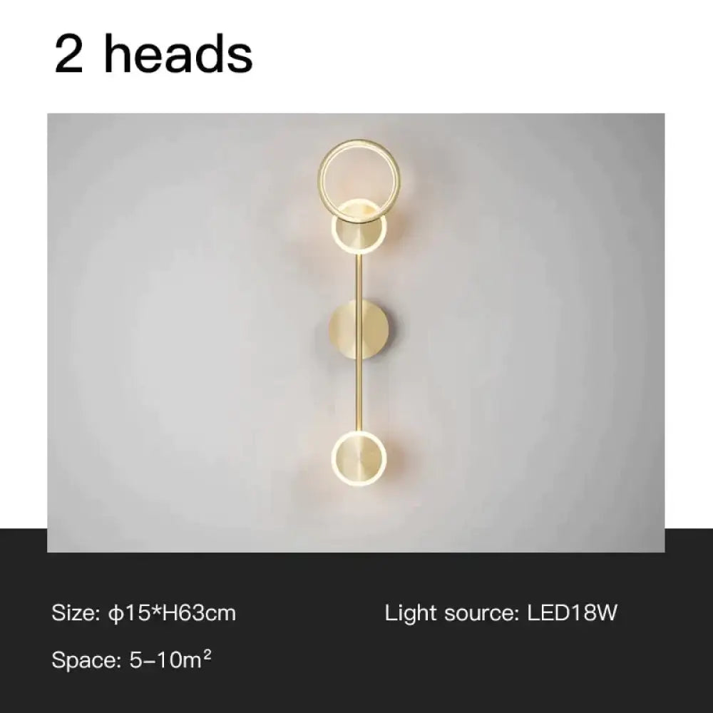 Modern golden geometric led wall lamp with two circular light heads on slender rod for living room use
