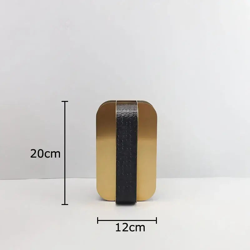 A sleek rectangular clutch with a glossy gold metallic exterior and black textured strip from decorbites golden geometry decor