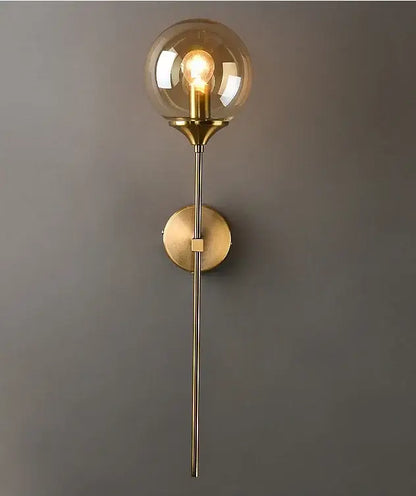 A modern golden glass ball wall lamp brass sconce with a spherical amber smoked globe for bedroom decorbites decor