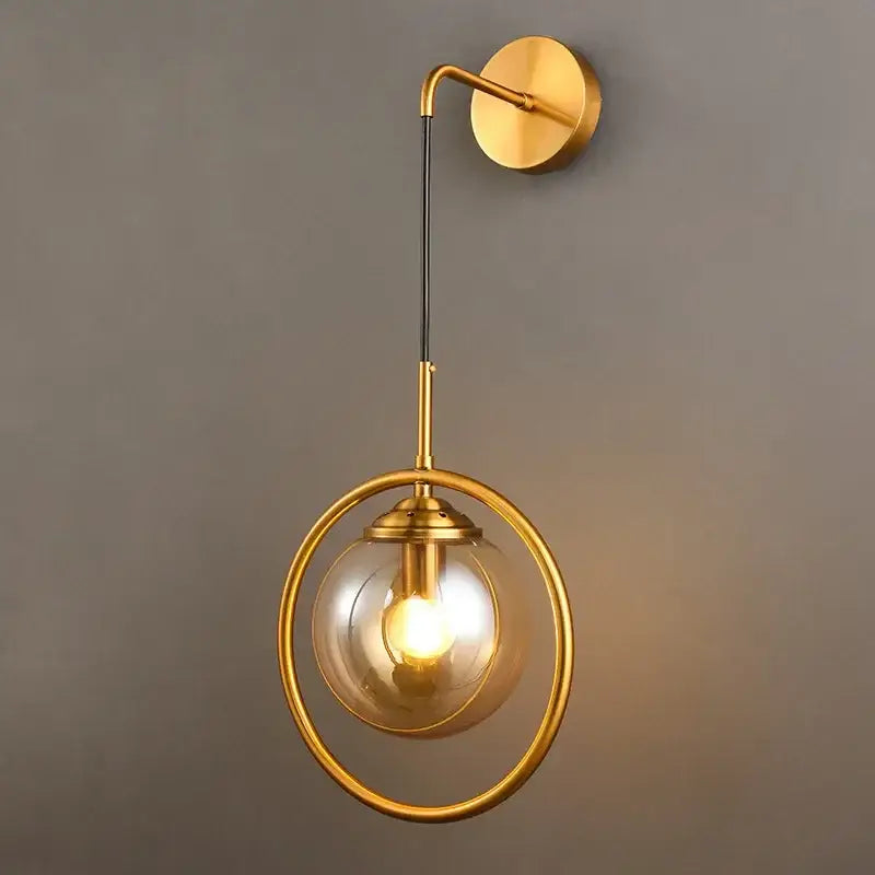 Modern golden glass ball wall sconce with a decorbites golden glass globe in an ornate brass ring for living room decor