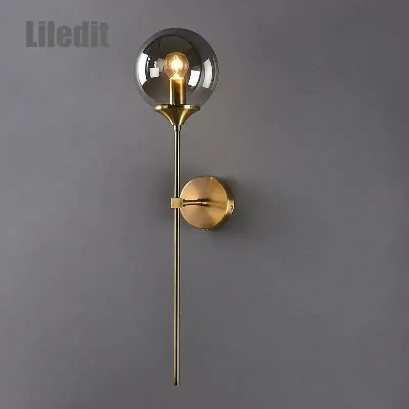 Modern golden glass ball wall sconce with a gold-toned metallic stem and spherical smoked glass for living room decorbites golden glass lighting