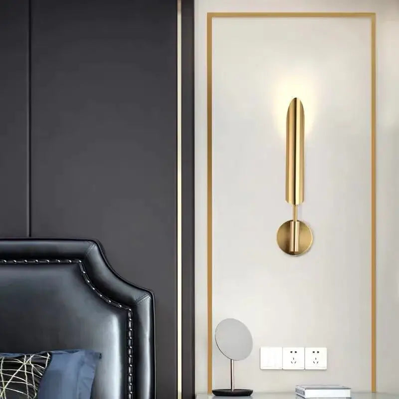Gold-finished modern wall light with sleek elongated vertical design and circular base by decorbites golden inclined tube
