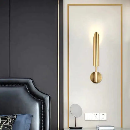 Gold-finished modern wall light with sleek elongated vertical design and circular base by decorbites golden inclined tube