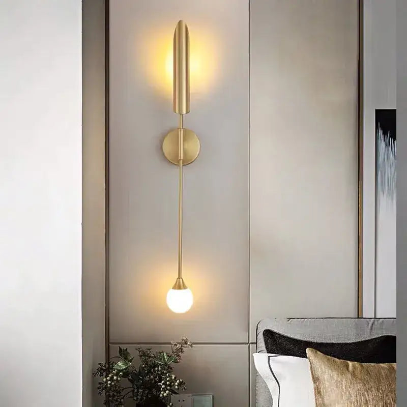 Modern golden inclined tube wall light with sleek elongated design and spherical bulb for living room decorbites golden inclined
