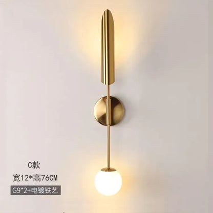 Modern golden inclined tube wall light with gold-toned stem and frosted glass bulb for stylish living room decorbites golden inclined