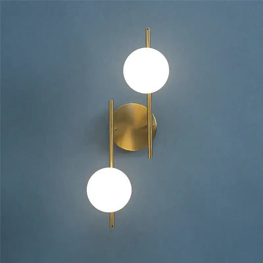 Modern golden led wall sconce with two spherical milky glass shades ideal as wall lights for bedroom decorbites golden led