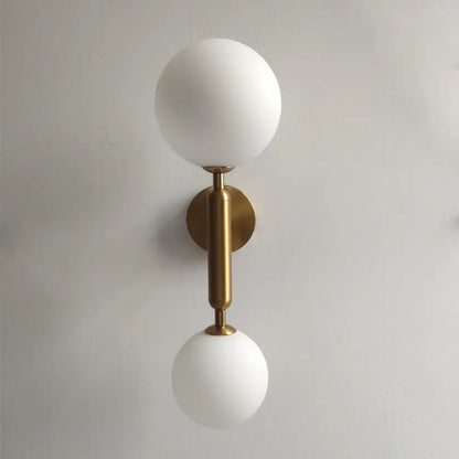 Modern golden led wall sconce with milky glass globes on polished brass stem for bedroom decorbites golden led wall