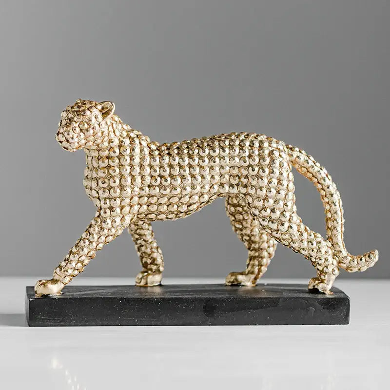 Modern golden leopard resin figurine with textured bead surface on black base for living room decor by decorbites